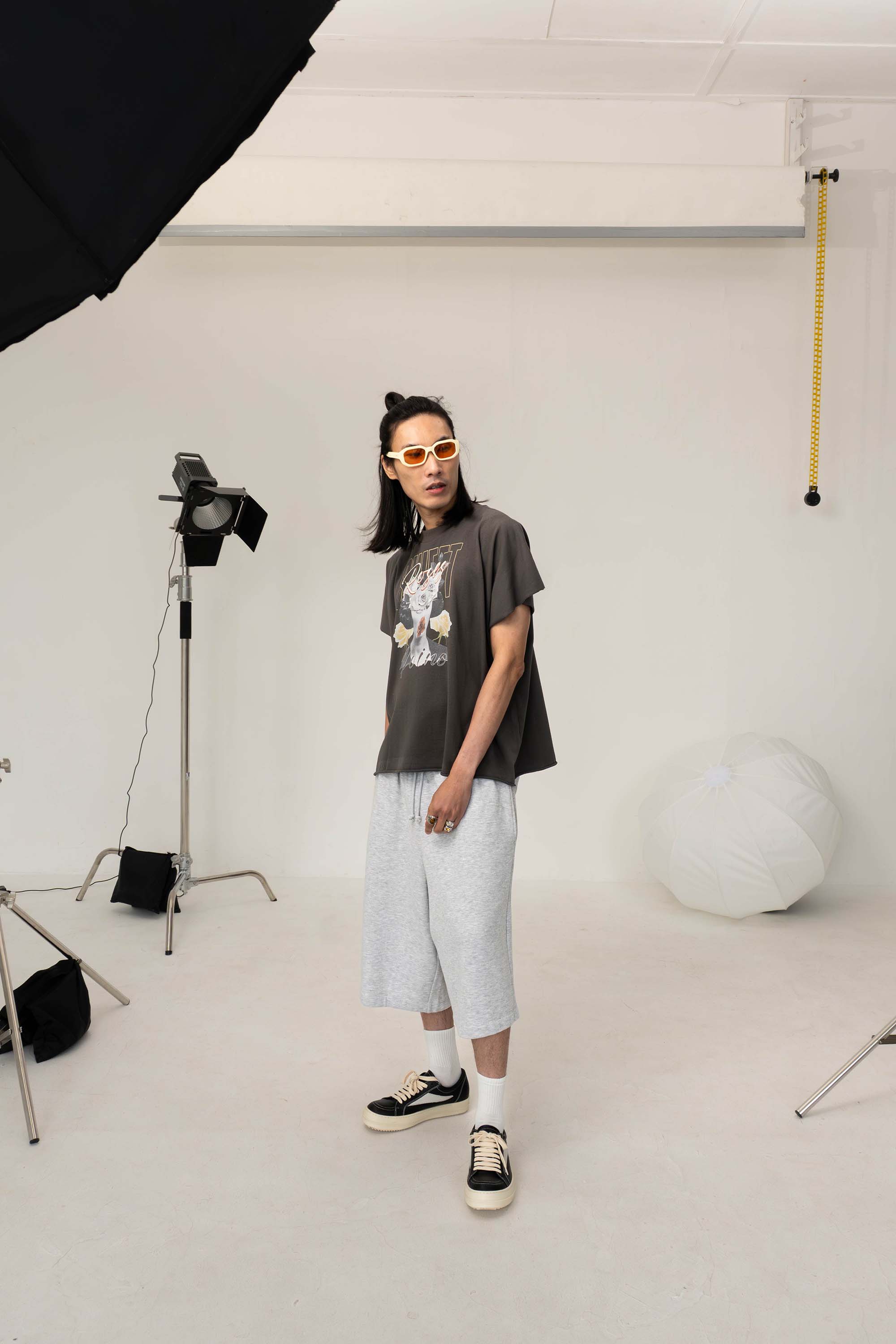 Man with shorts and t shirt in photography studio in Belfast